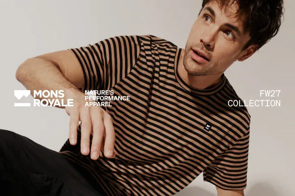 Male model in a brown and black striped T-shirt poses for the Mons Royale FW27 collection.