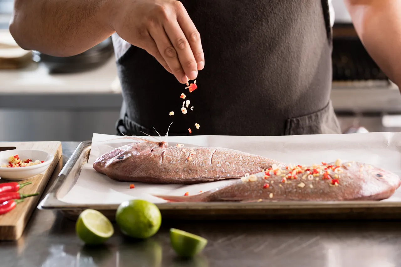 Whole snapper with garnish and limes