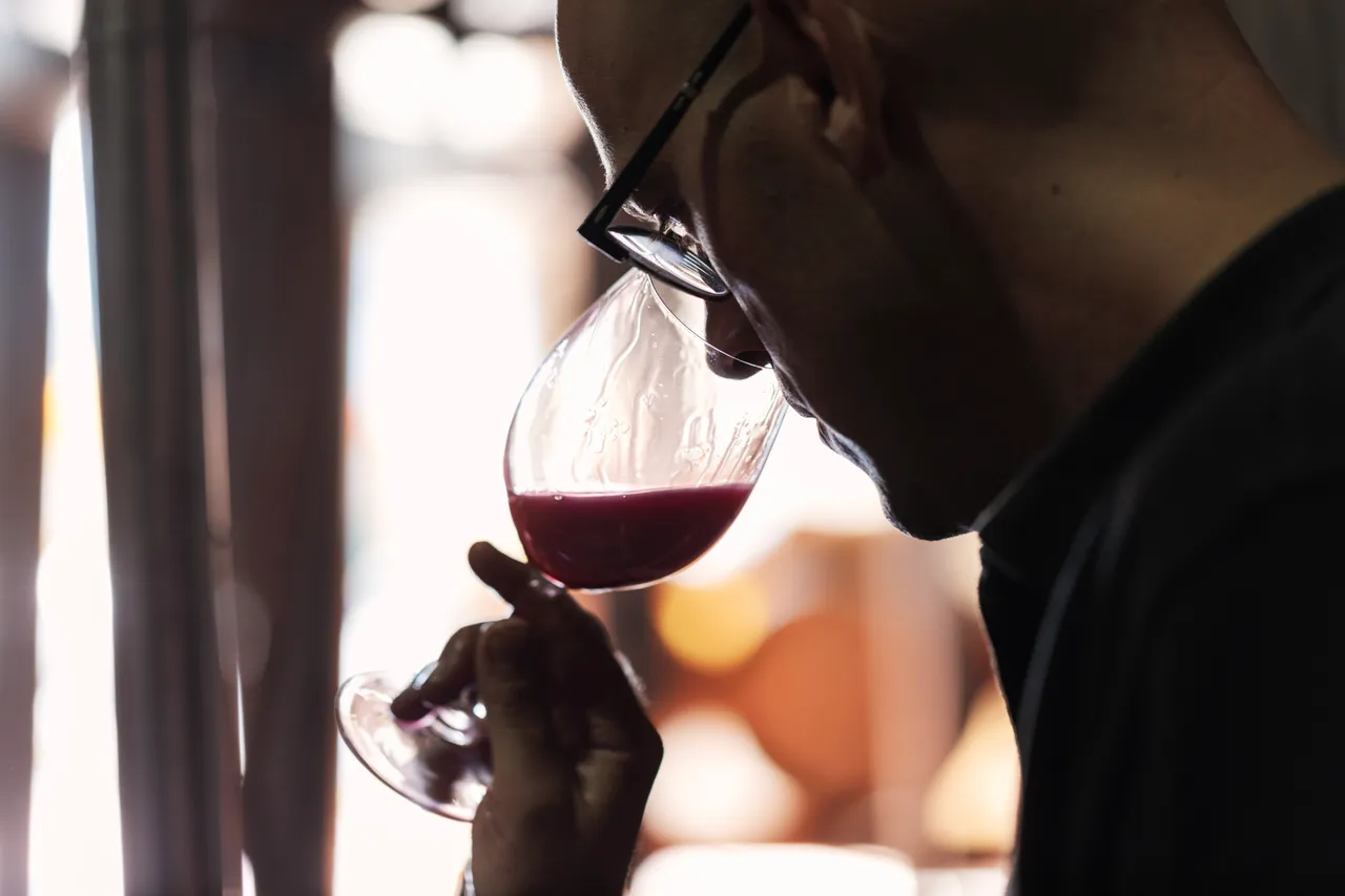 Winemaker smelling wine