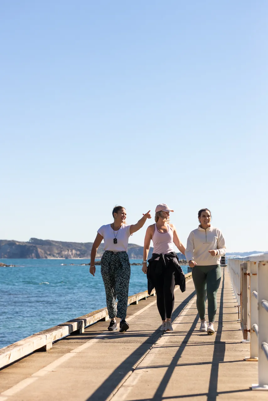 Women walk down wharf