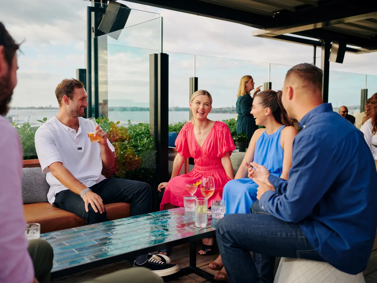 Group of friends laughing at bar