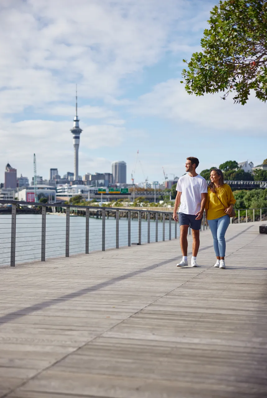 Couple walking along Westhaven Path with the City in the background