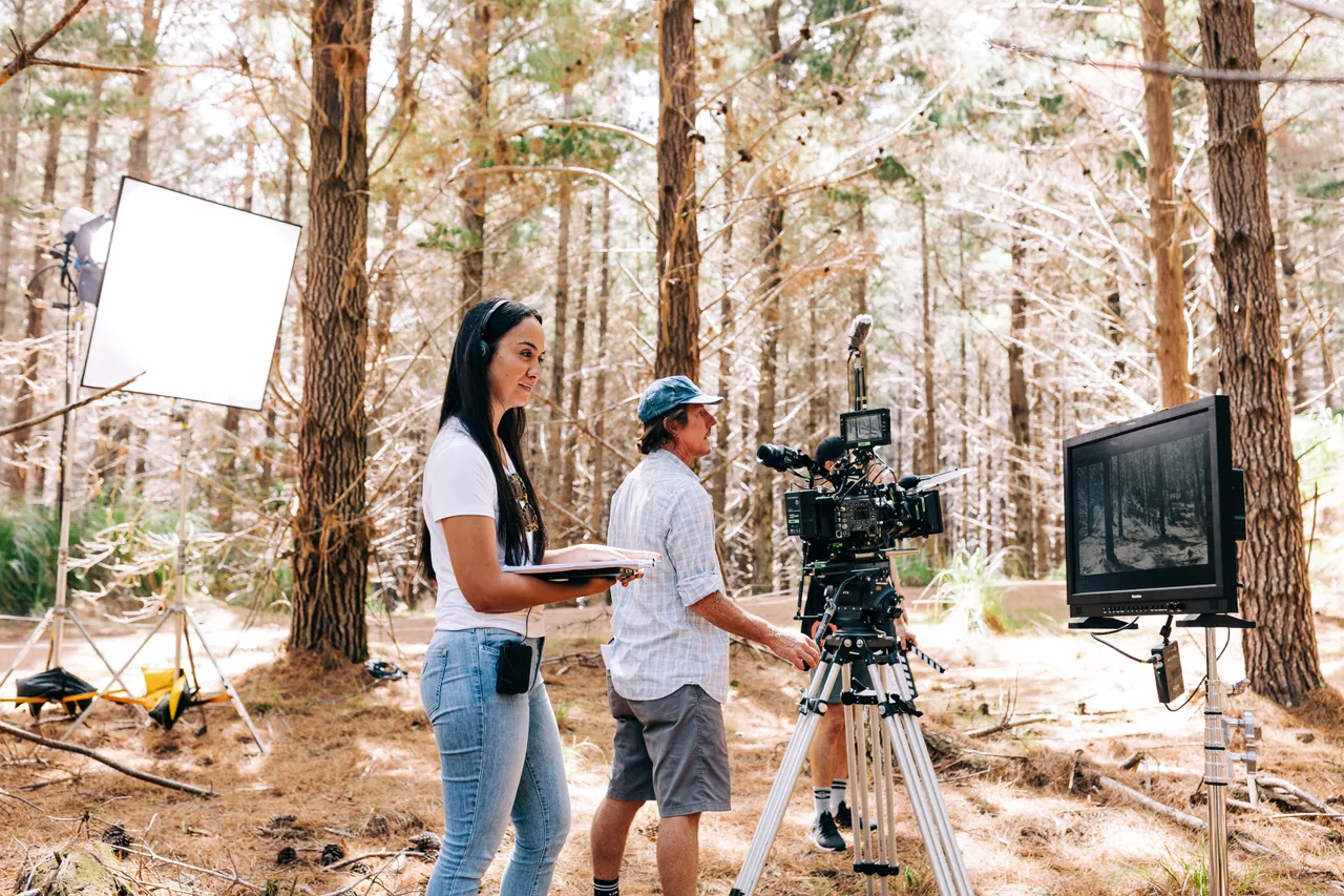 Cinematographer lines up shot while director reviews on monitor