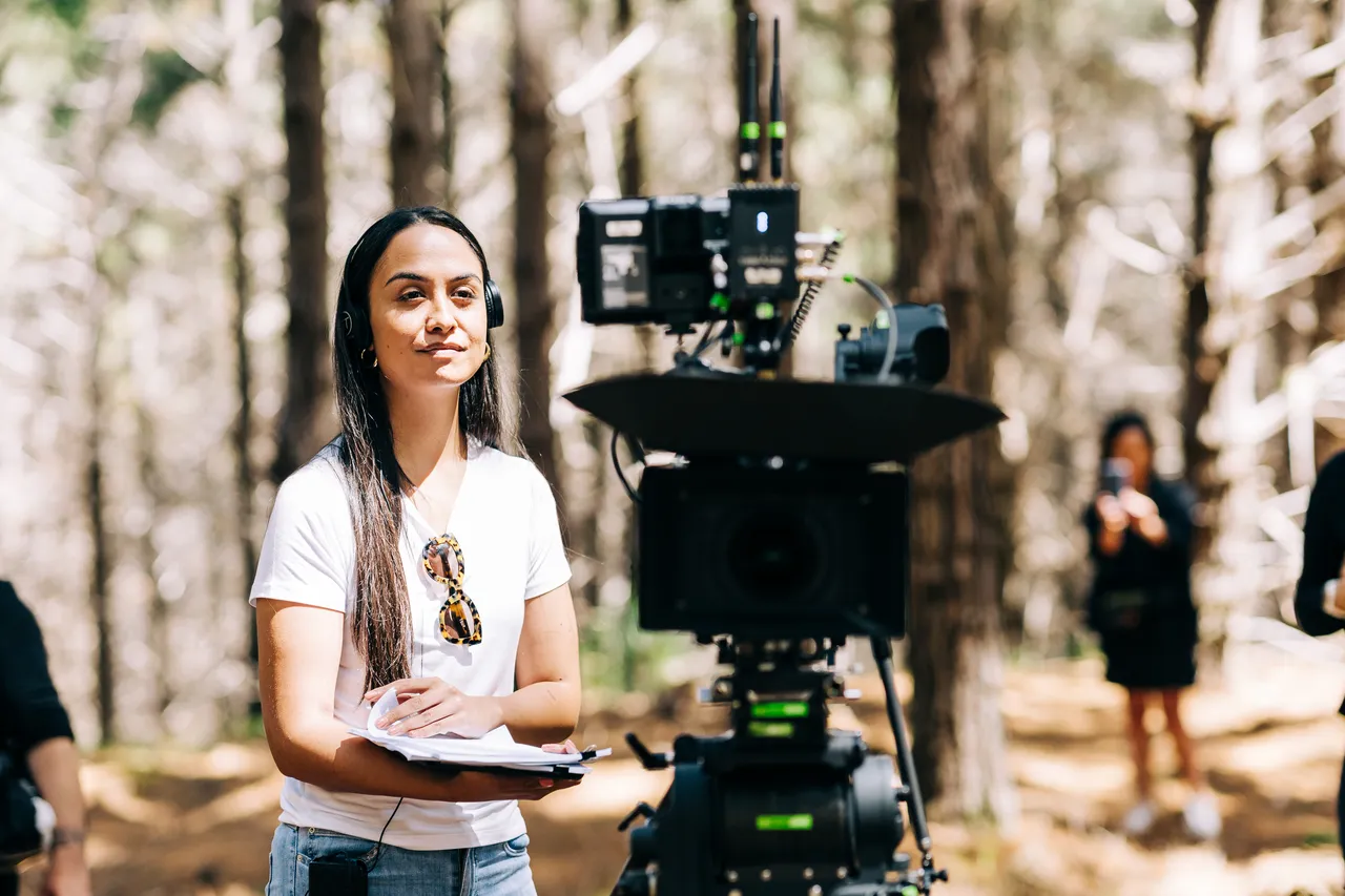 Behind the scenes shot of director with camera equipment
