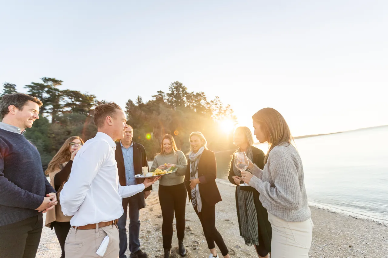 Delegates being served oysters on beach
