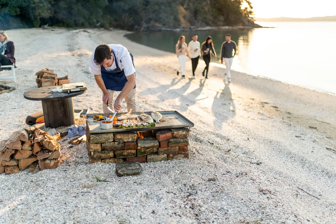 Chef preparing meal on beach
