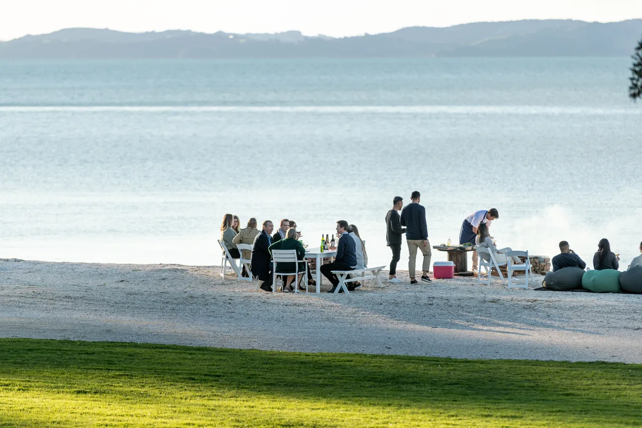 Delegates have a meal on private bay