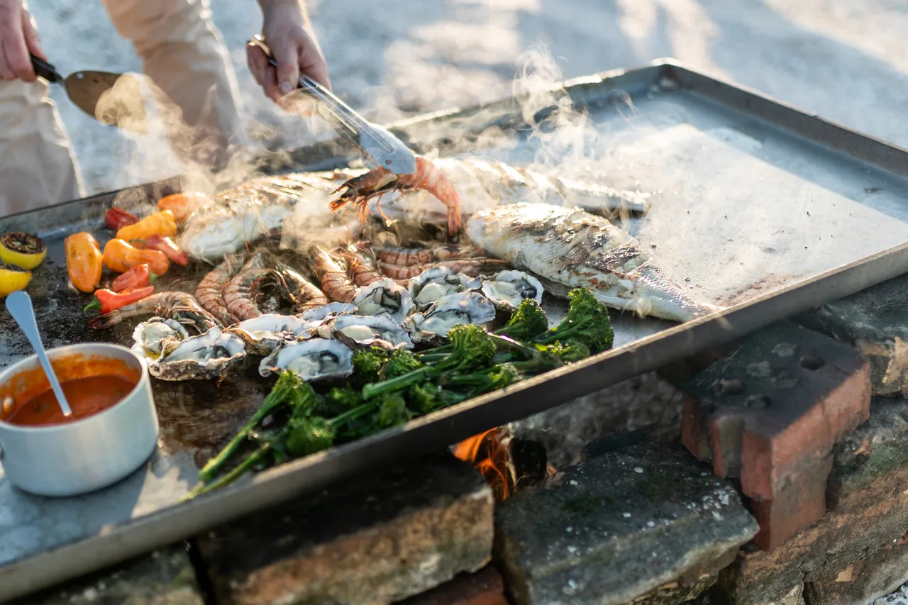 Close up of chef preparing meal on beach
