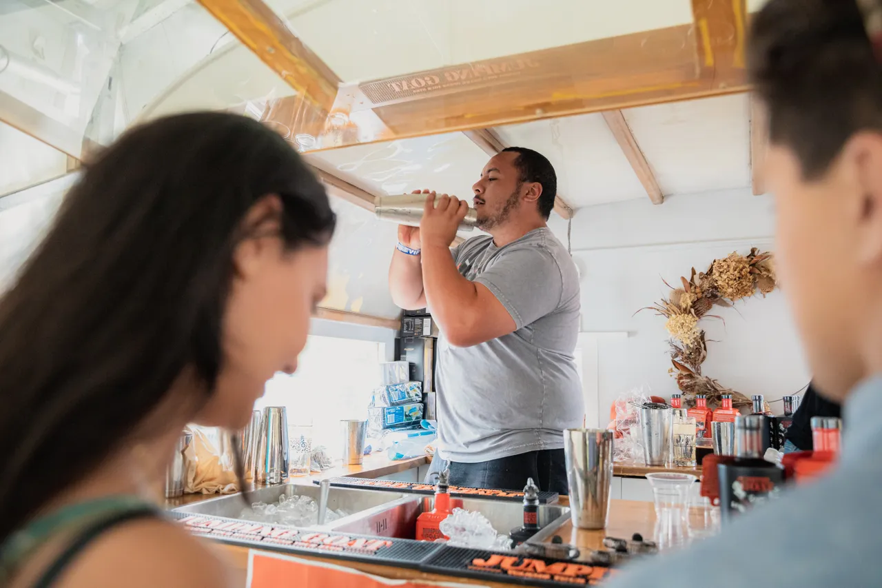 Bar tender making drinks