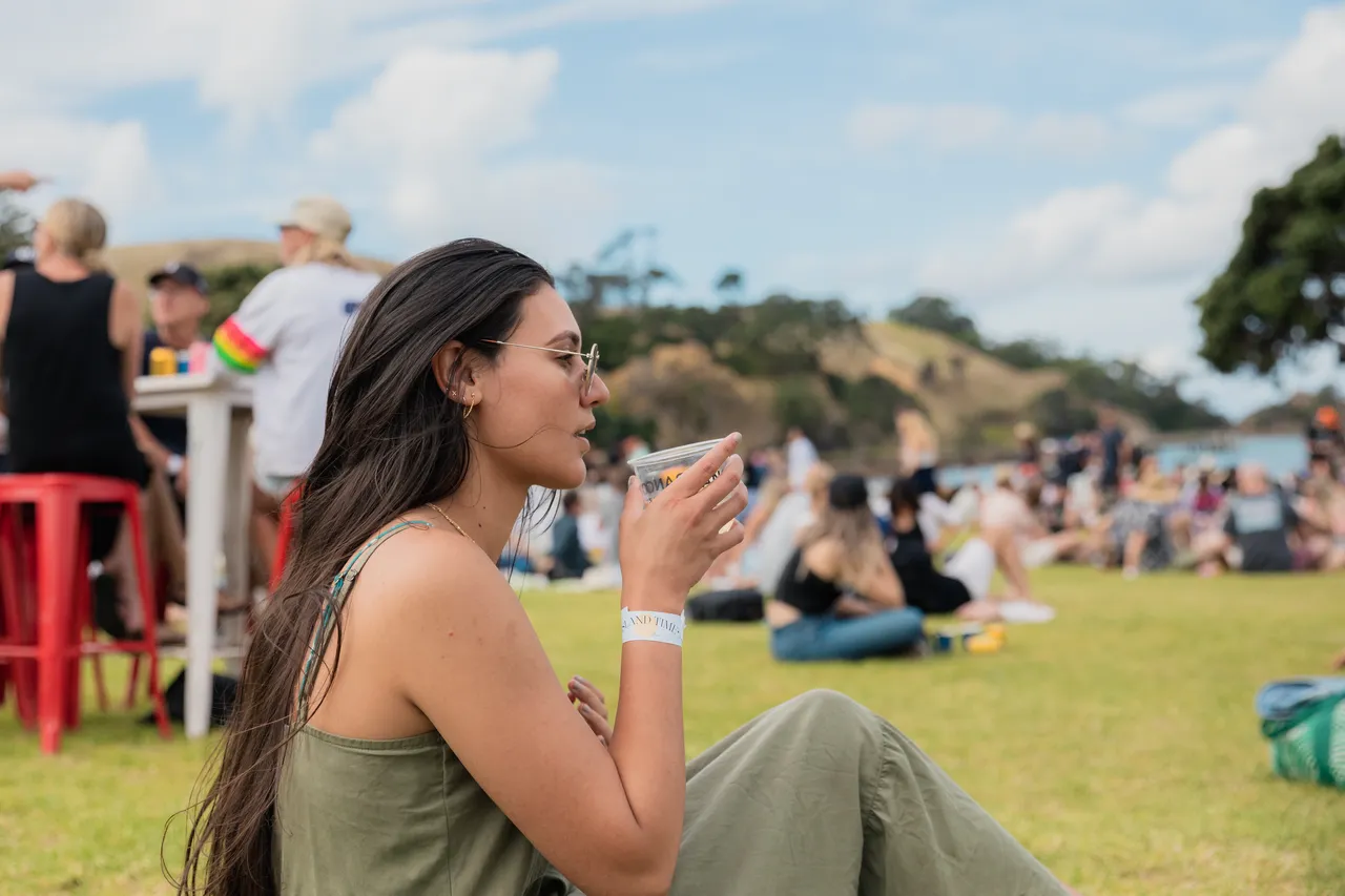 Woman enjoying a drink at festival