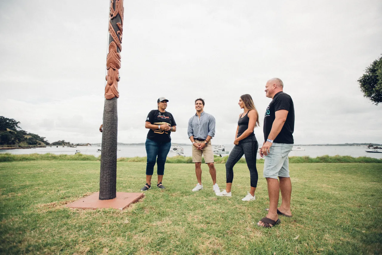 Group standing next to Pouwhenua
