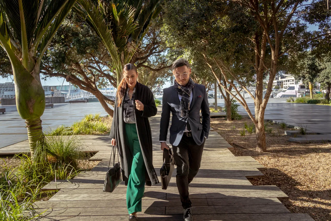 Female and male delegates walk to meeting