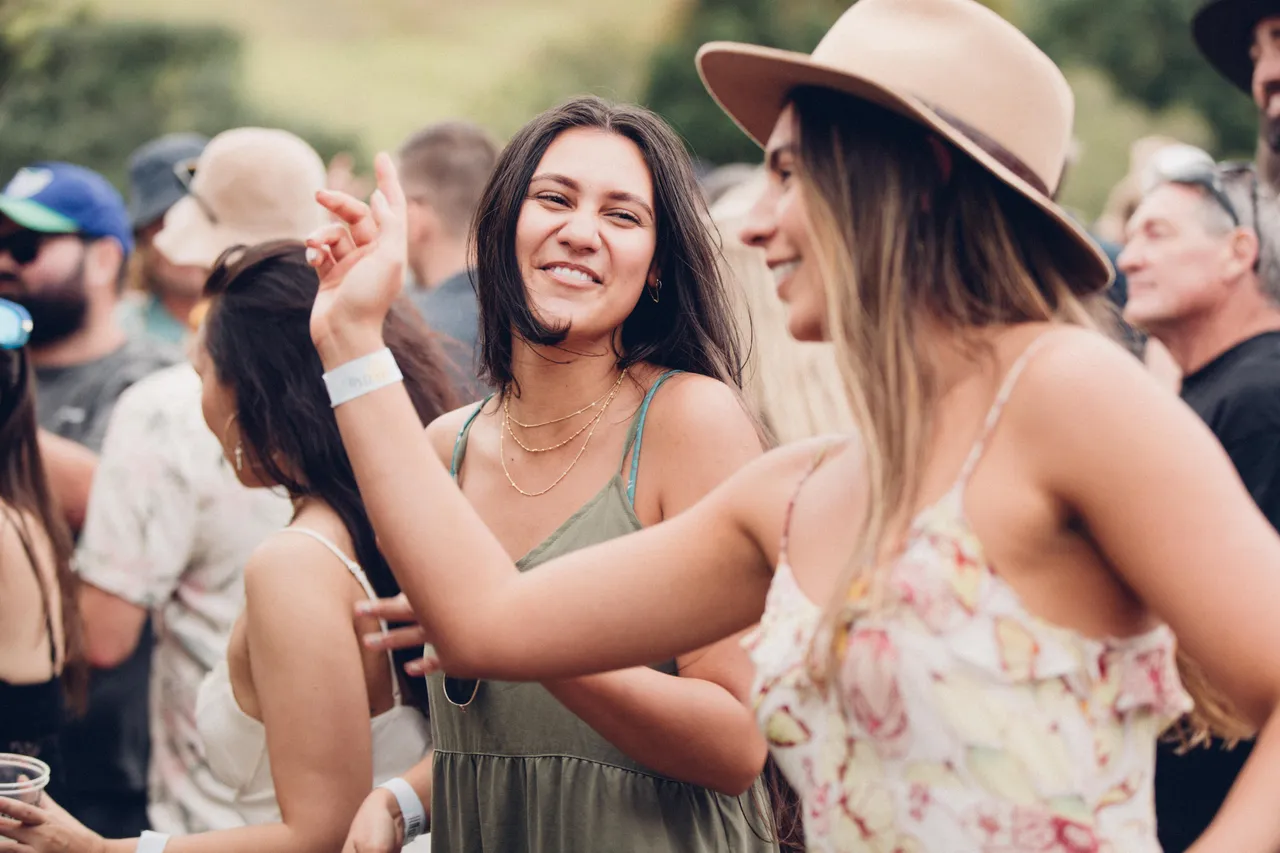 Ladies dance amongst the crowd at festival
