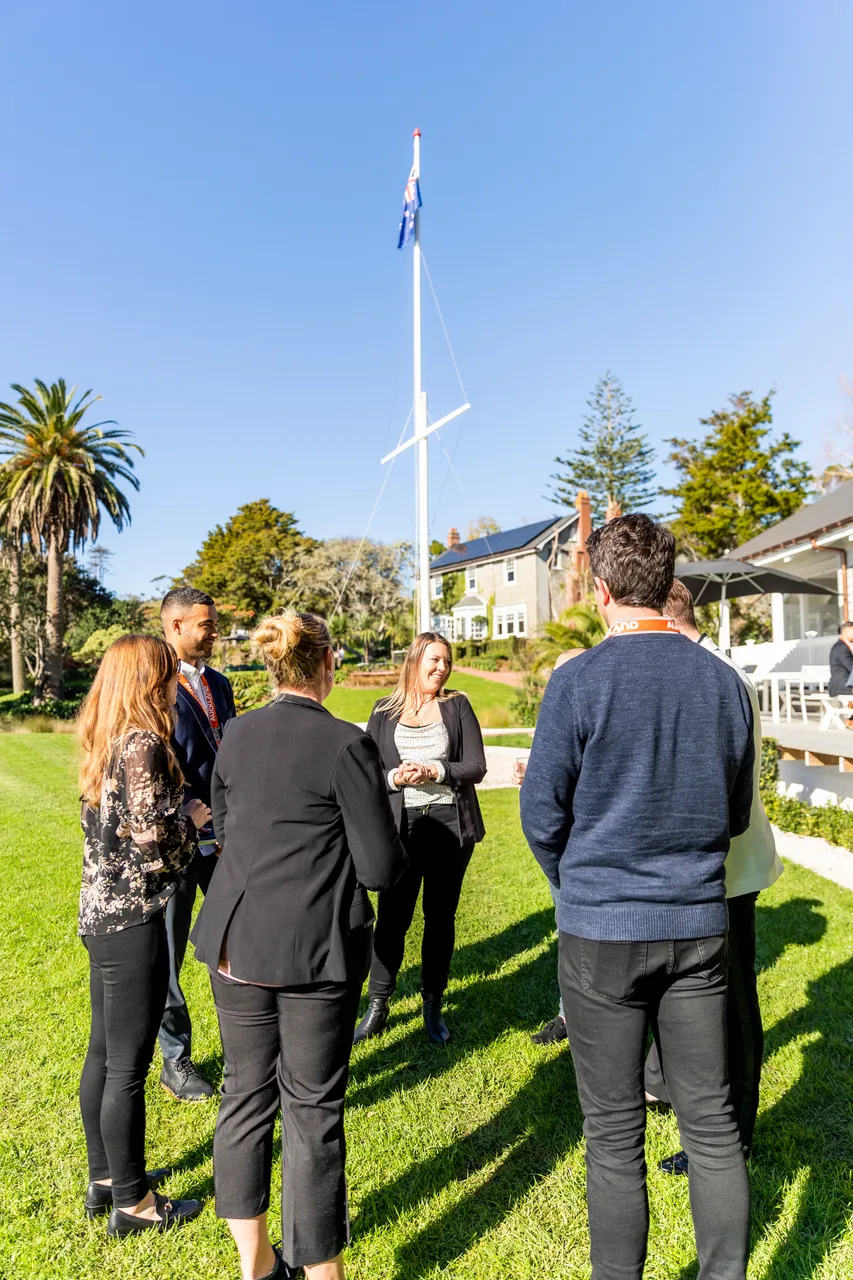 Delegates standing by flagpole