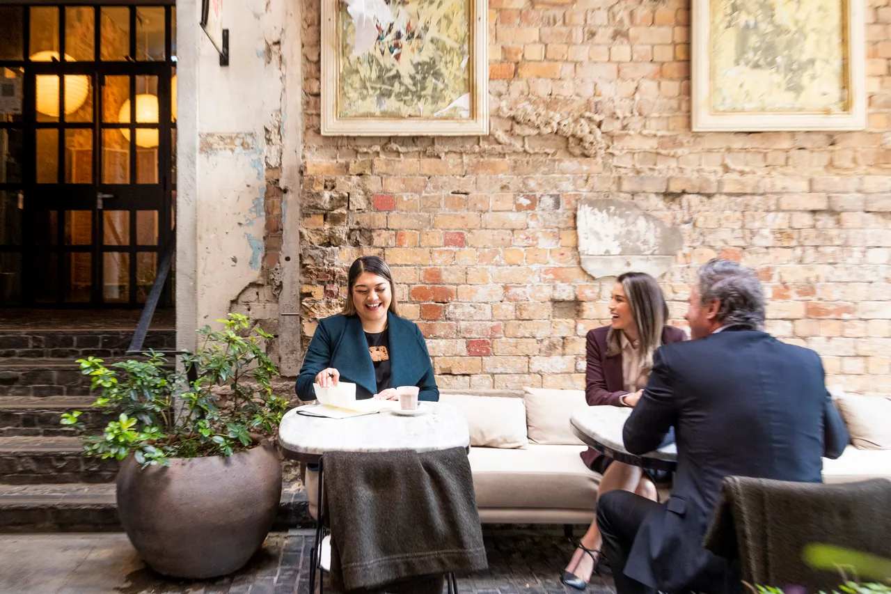 Delegates smile in cafe