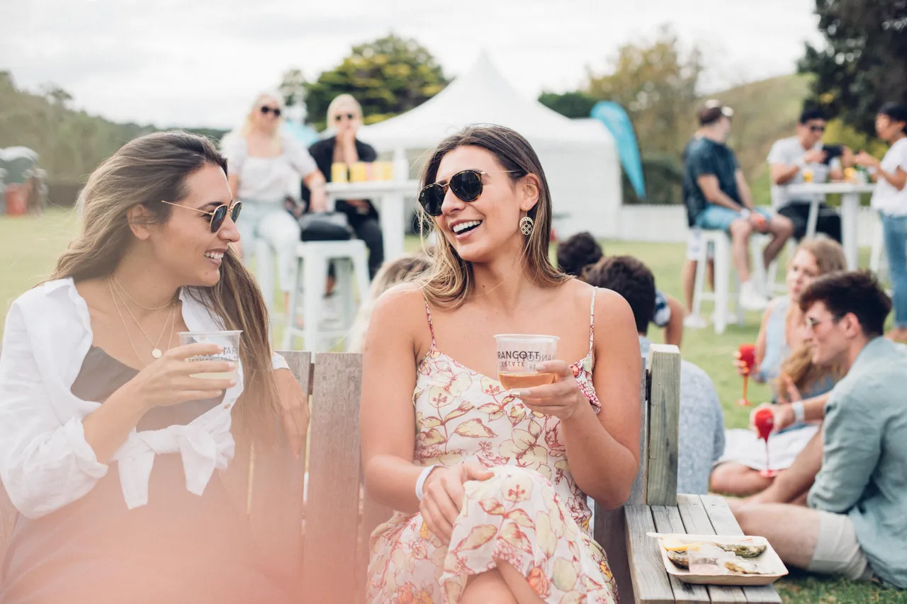 Two ladies enjoying a drink and oysters