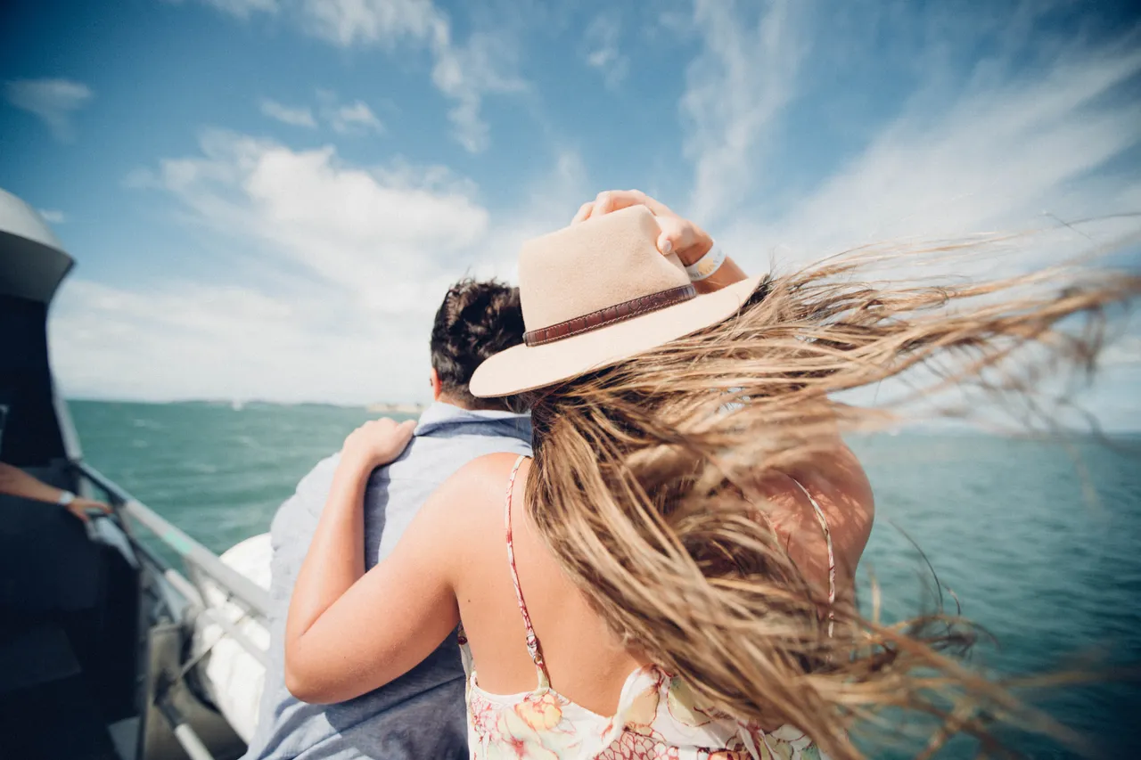 Couple admiring the surroundings while on a boat