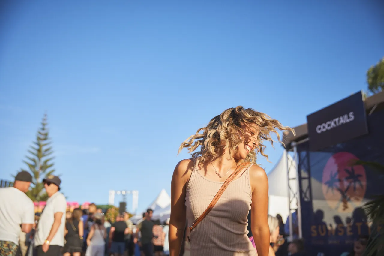 Woman dancing in the sunshine at festival