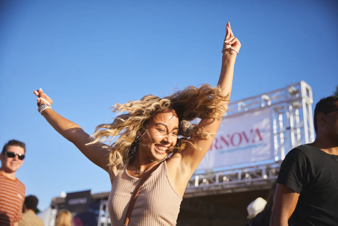 Woman dancing with arms up in the air