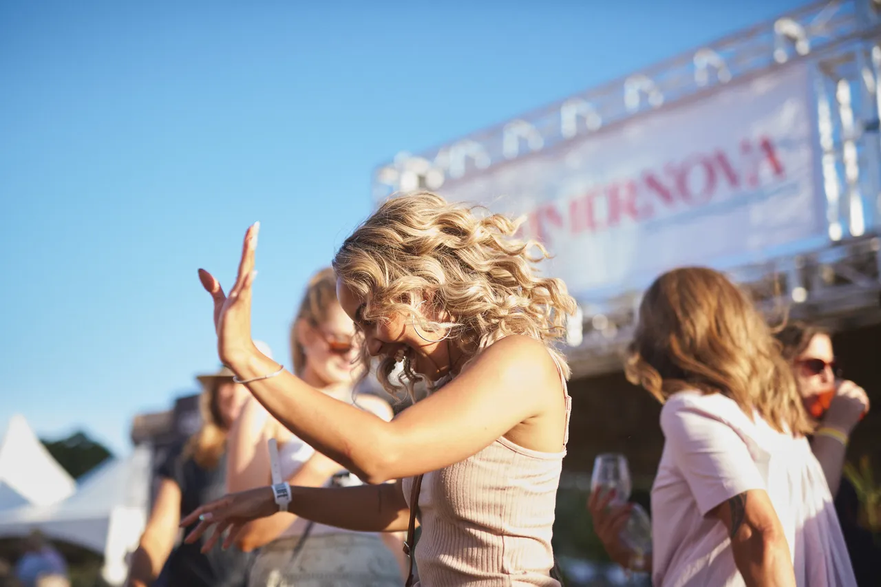 Woman smiling and dancing at festival