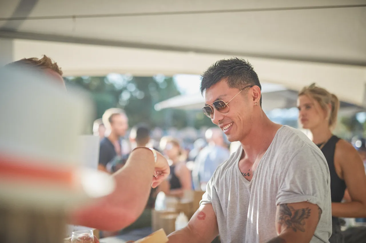 Man with tattoos smiling at festival