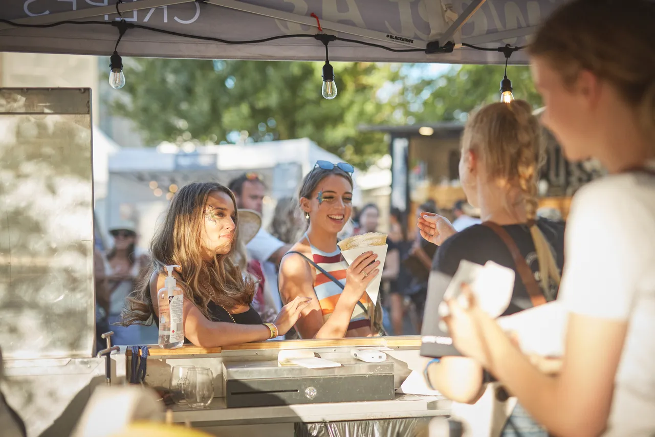 Two ladies buying crepes at food stall