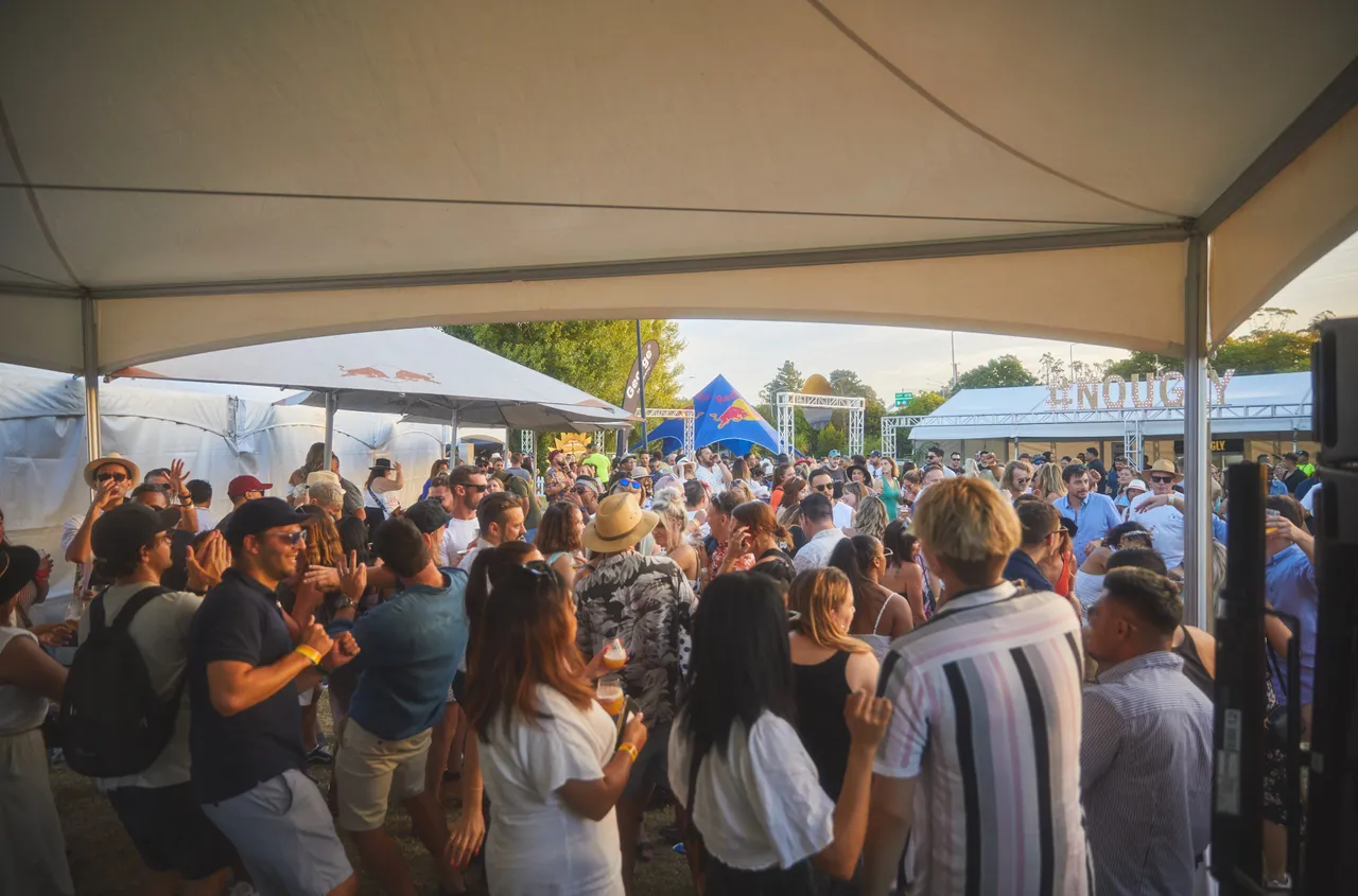 Crowd dancing at festival during the day