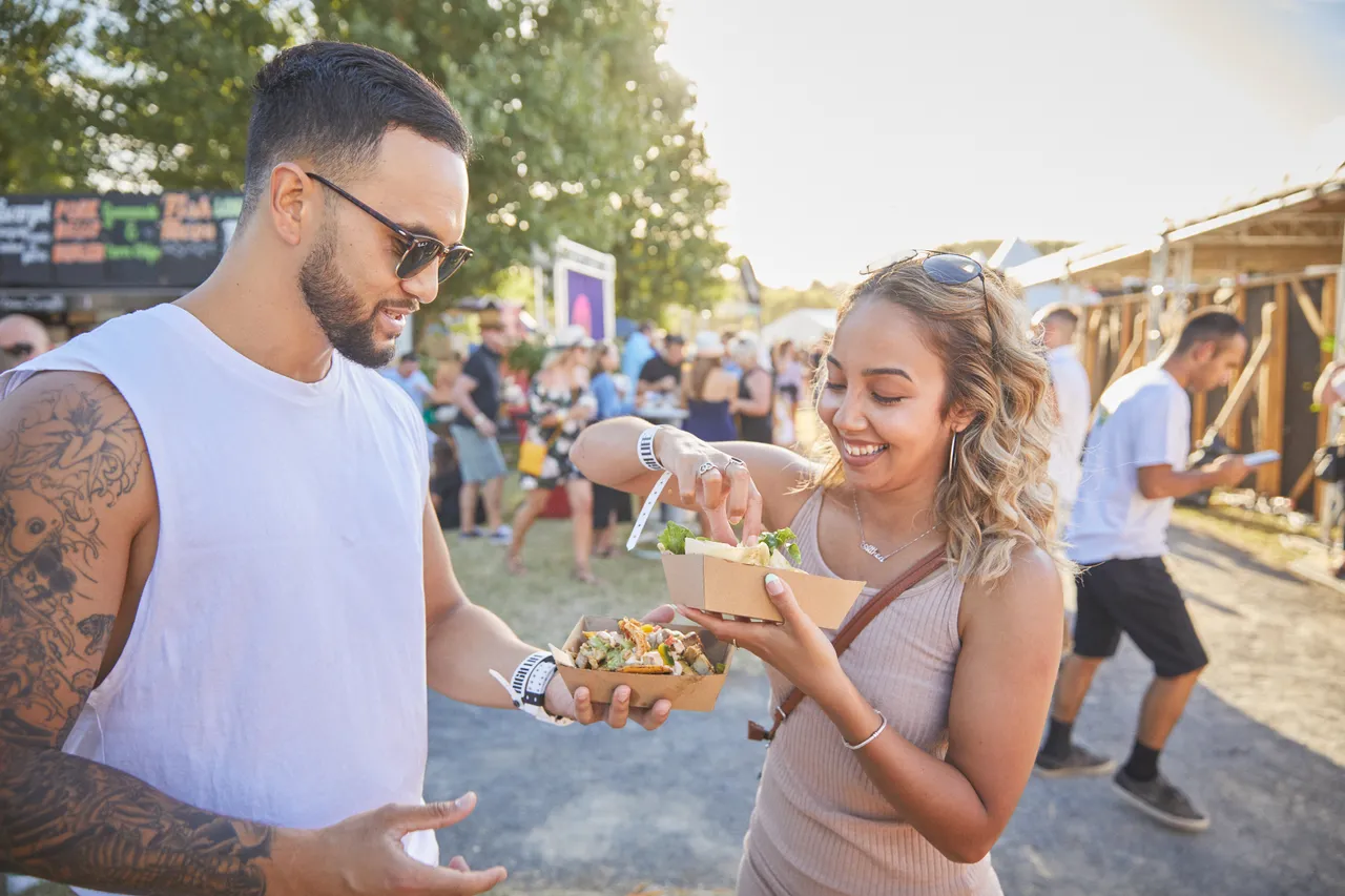 Couple enjoying food at festival