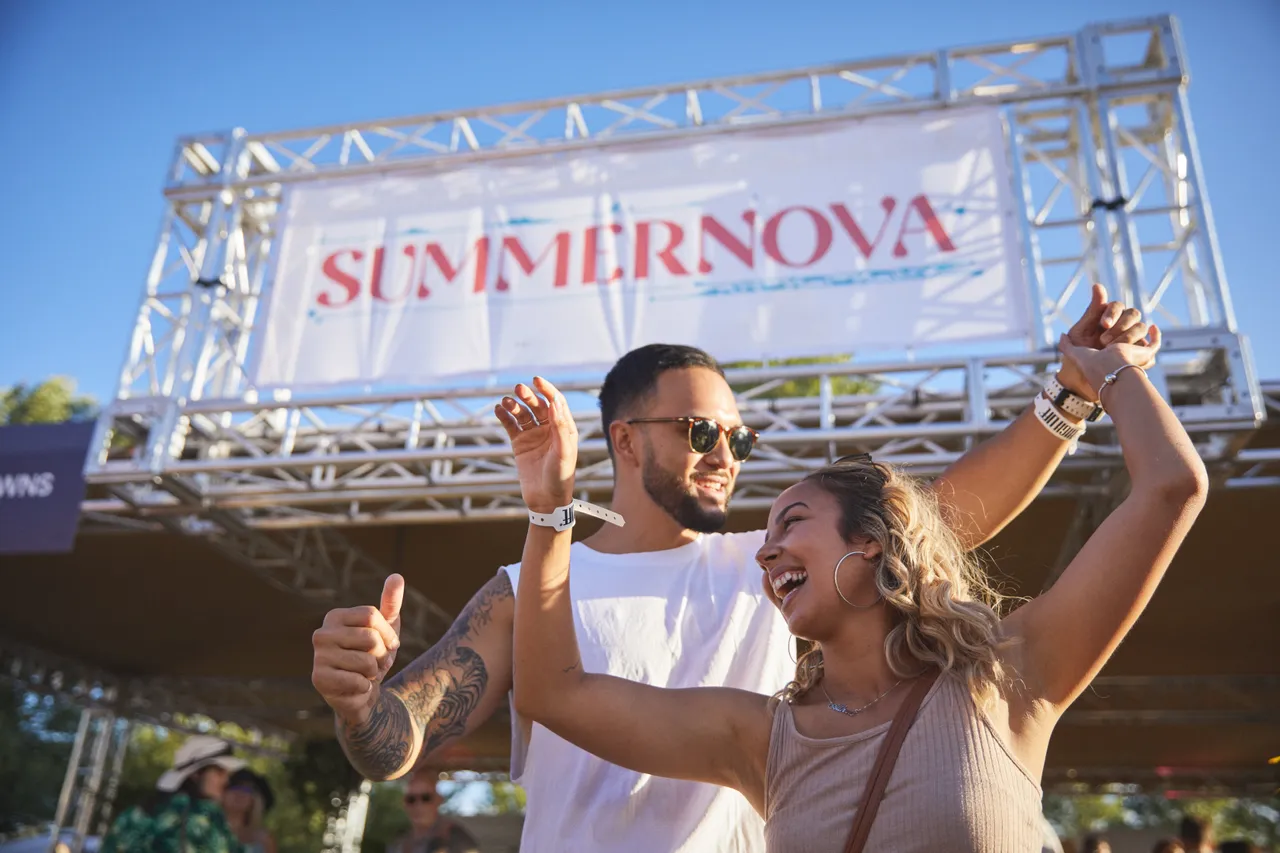 Couple dancing and laughing in front of stage