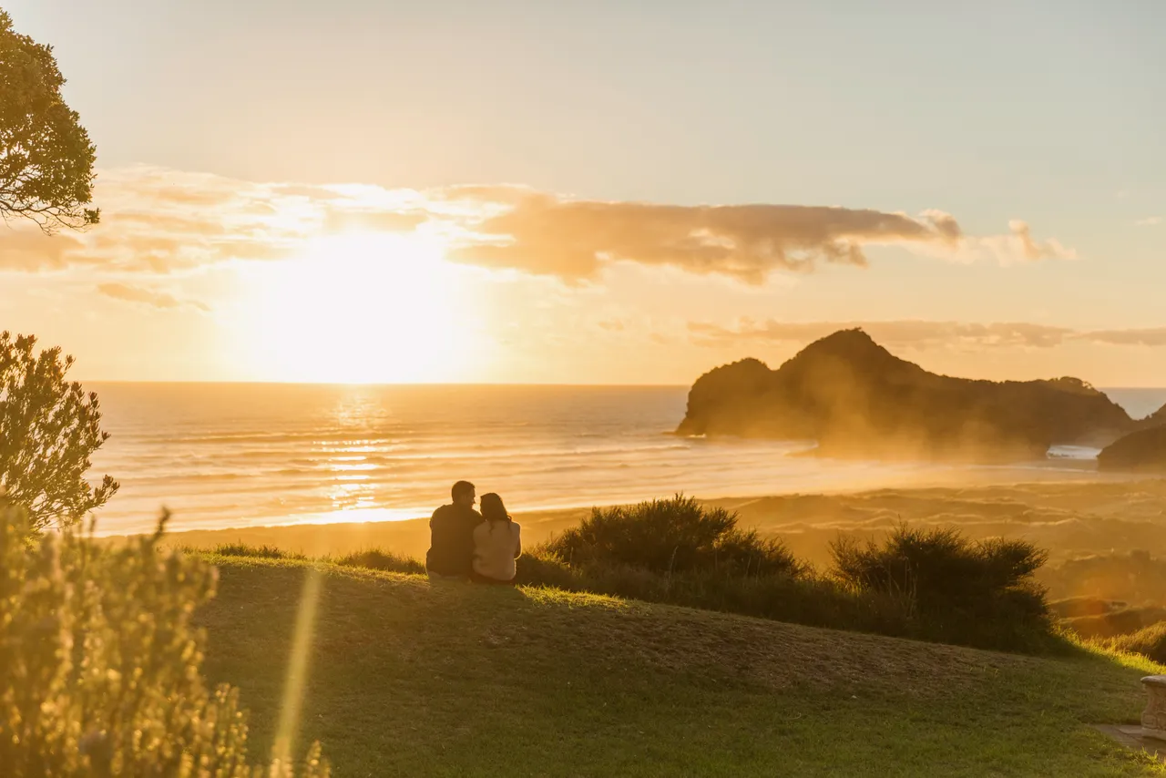 Couple watching the sunset by the beach