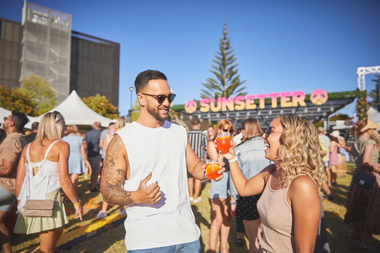 Man and woman toasting at Sunsetter festival
