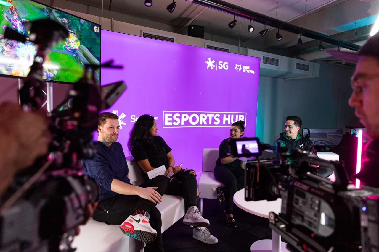 Group of young people sitting in front of two cameras at Spark NZ Esports Hub