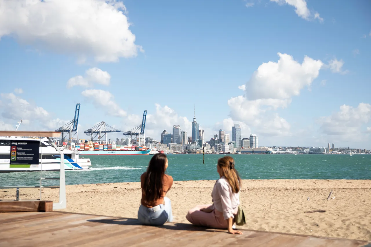 Women sitting watching Auckland skyline
