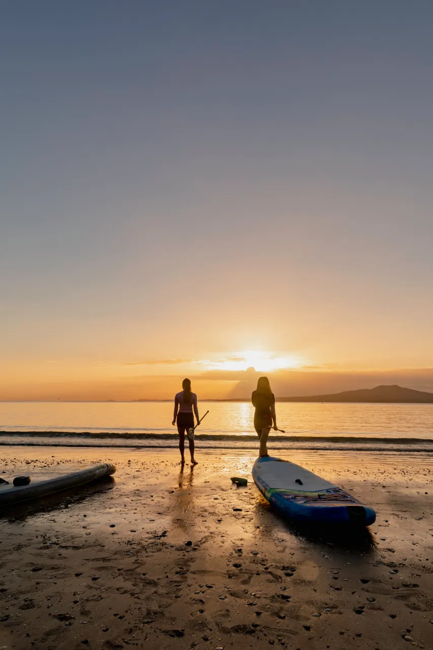Women preparing for a morning paddle board