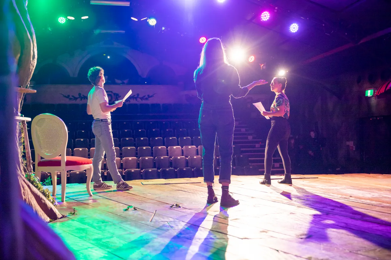 Auckland Brand Library - Three actors on stage rehearsing