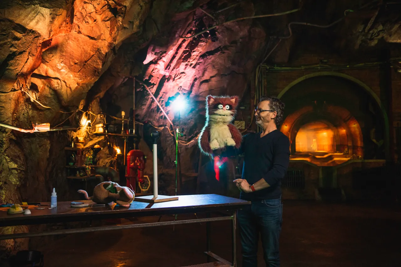 A puppeteer and his puppet in theatre