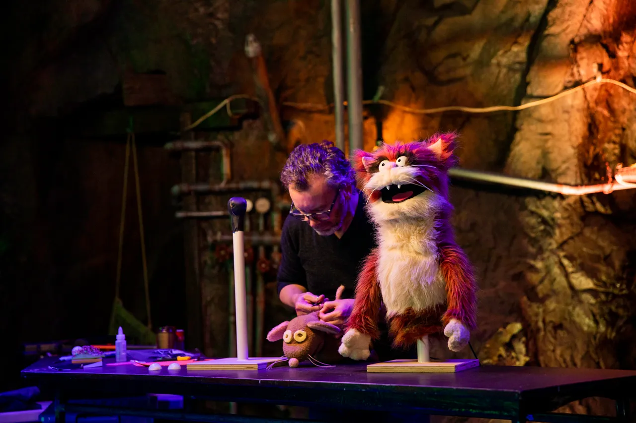 Cat puppet and puppeteer