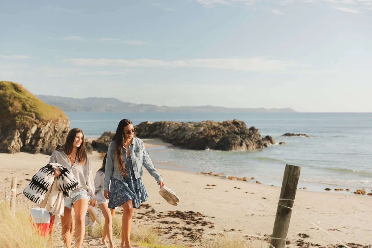 People walking on Auckland beach