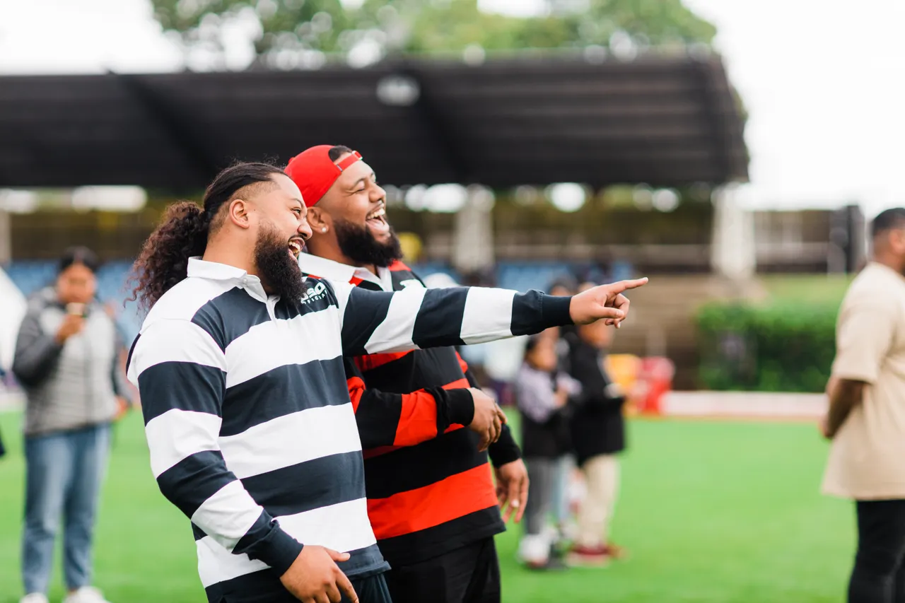 Two men laughing and pointing their finger