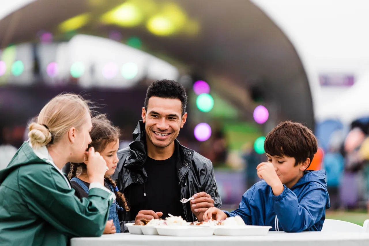 Family with two young children enjoying food
