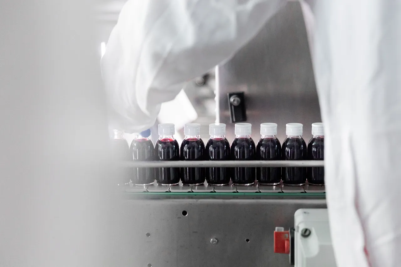 Filled bottles lined up on conveyor belt