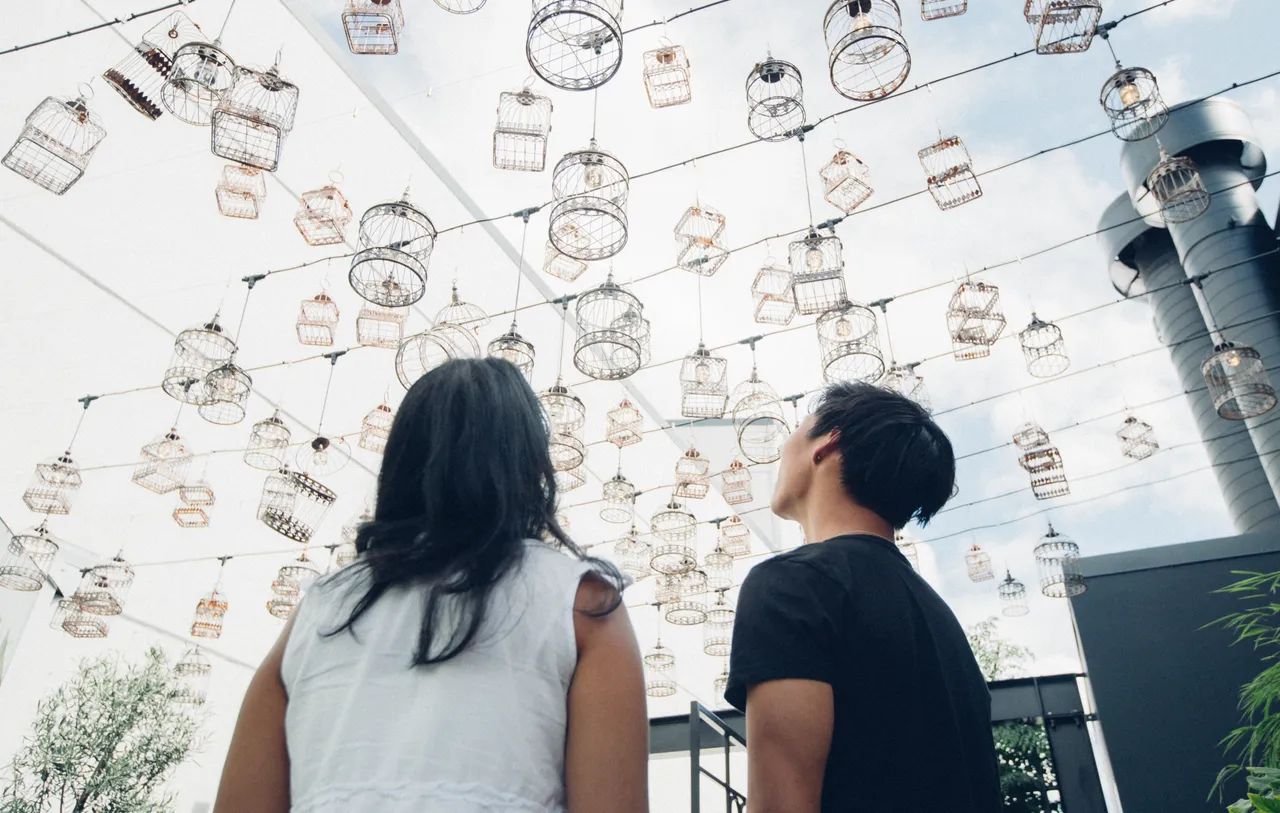 Woman and man admiring lamp shades