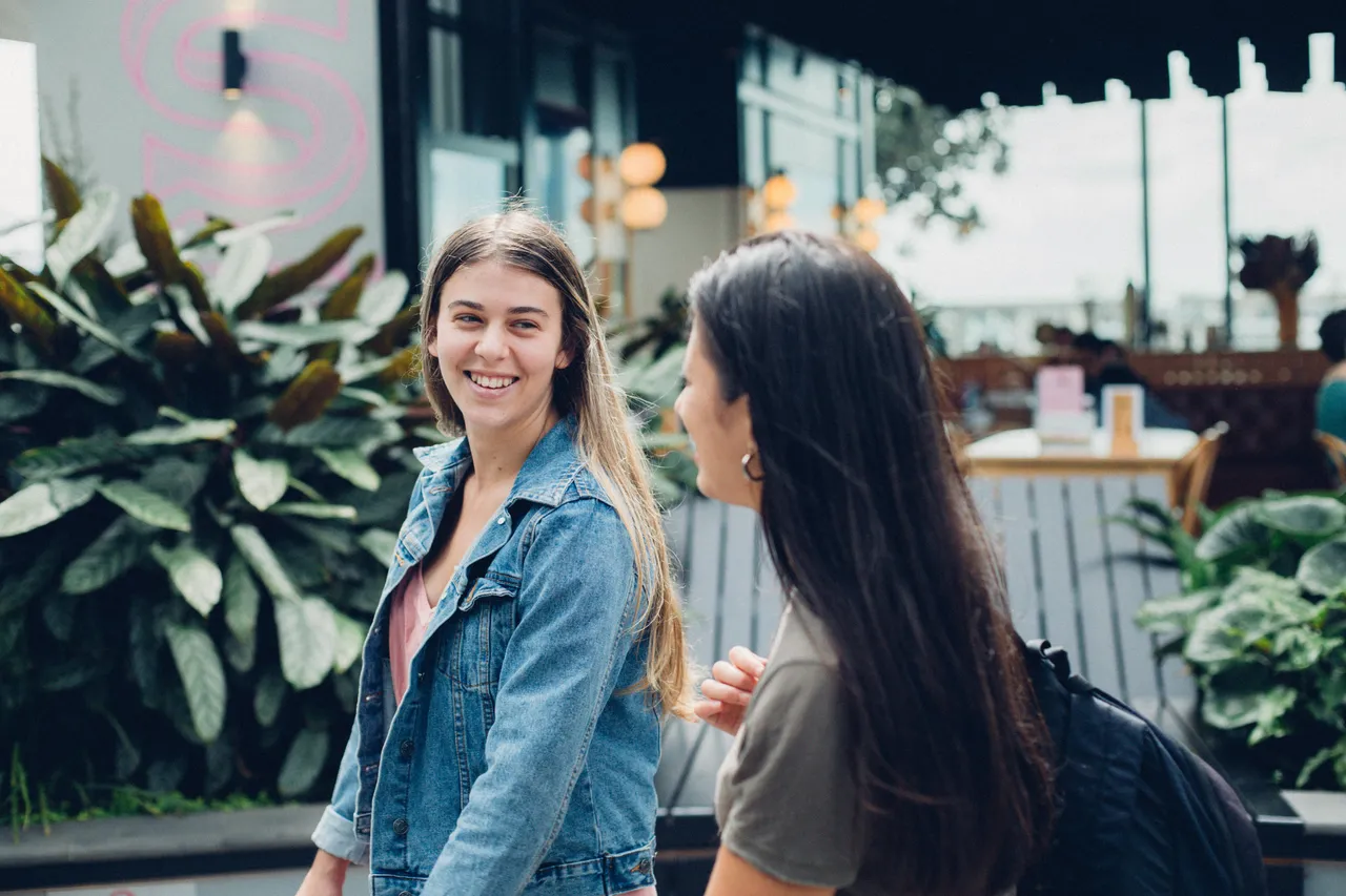 Two girls walking and smiling