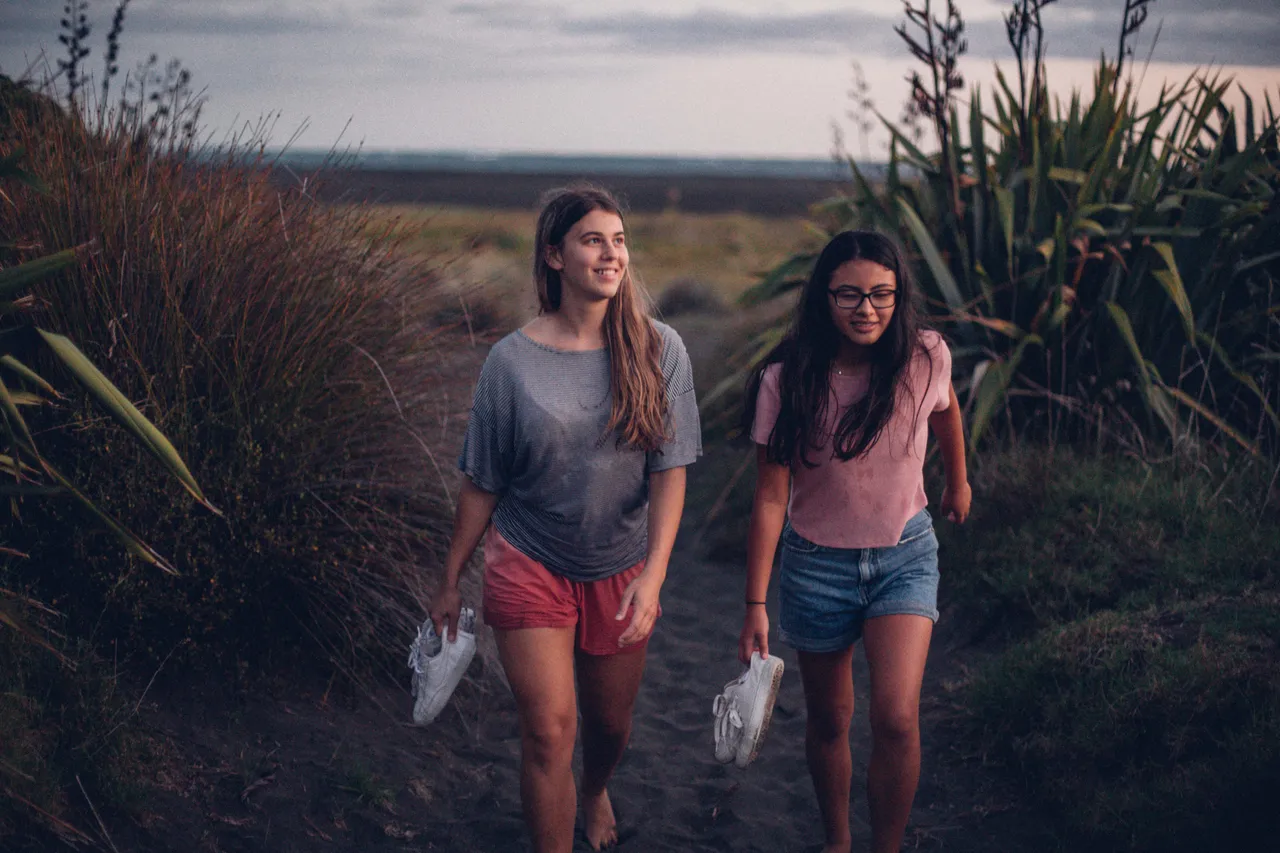 Two girls walking on the beach