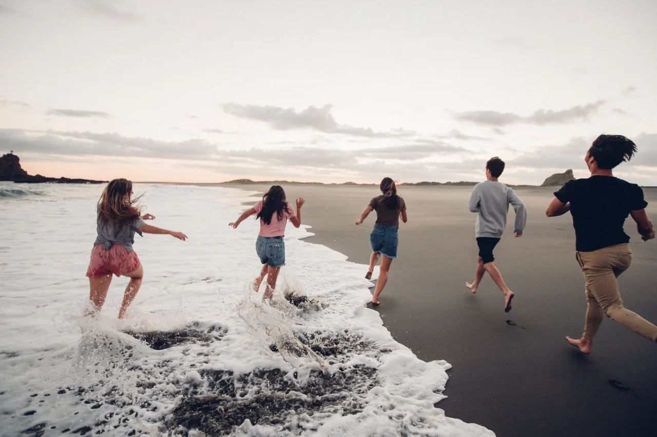 People running along the beach