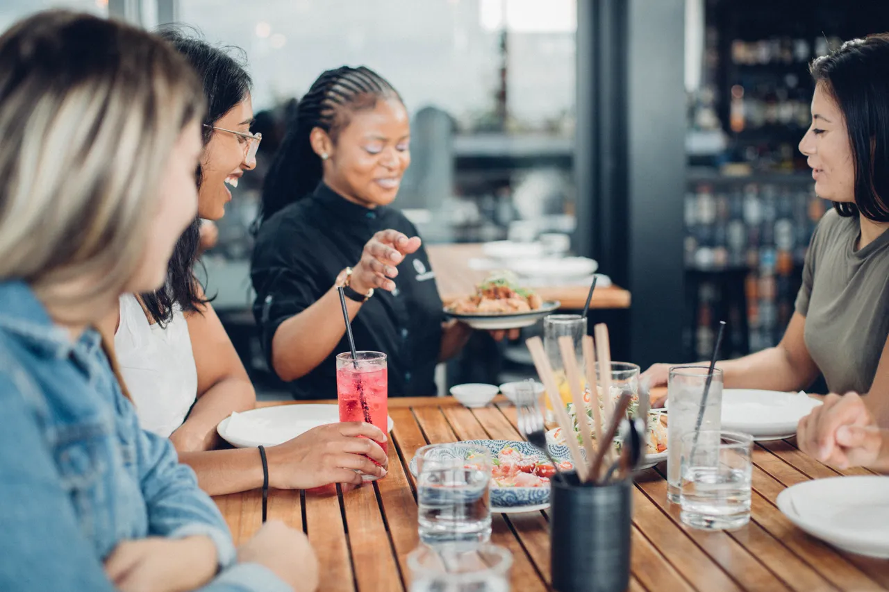 Girls receiving food at a restaurant