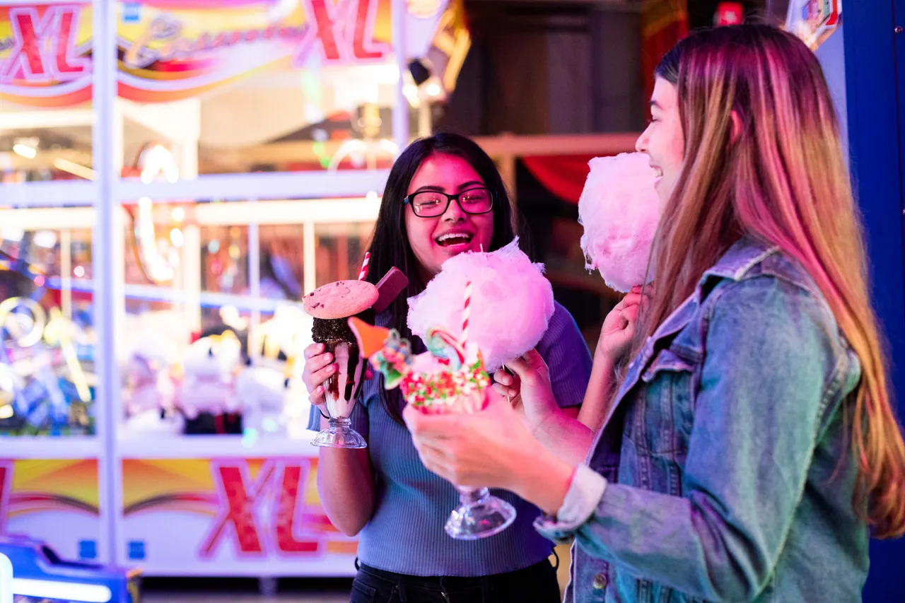 Girls enjoying milkshakes and candy floss