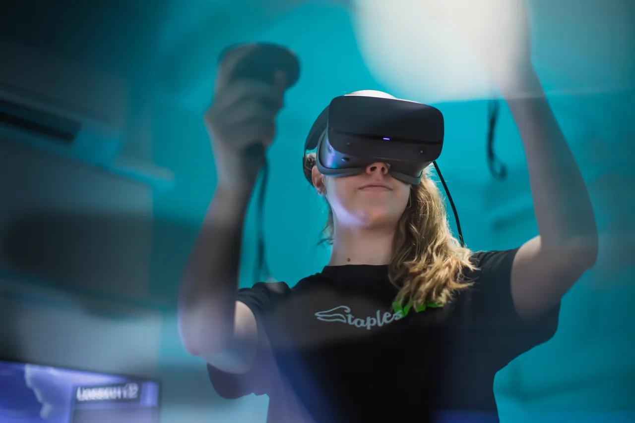 Woman wearing virtual reality headset in studio