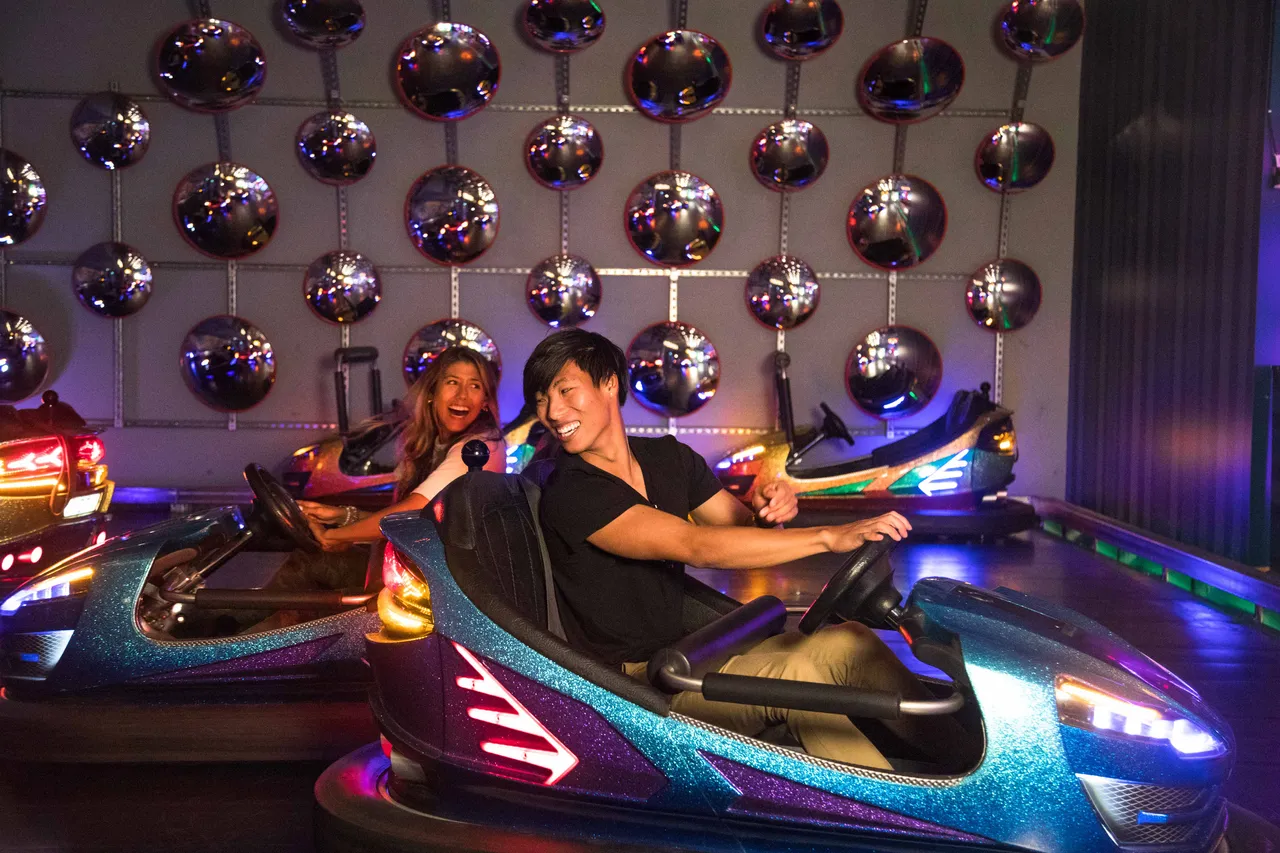 Girl and boy smiling on bumper cars