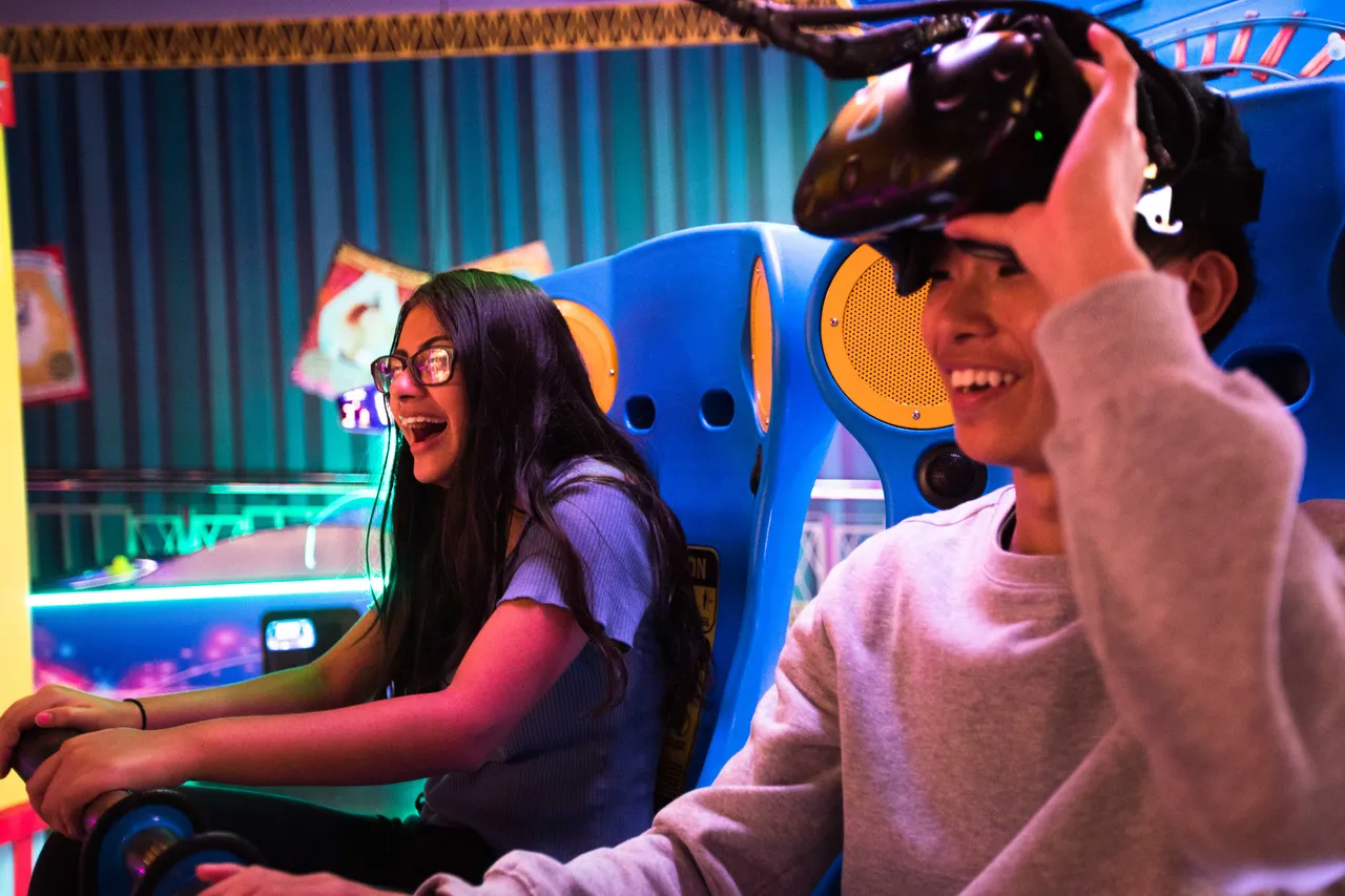 Girl and boy playing at the arcade